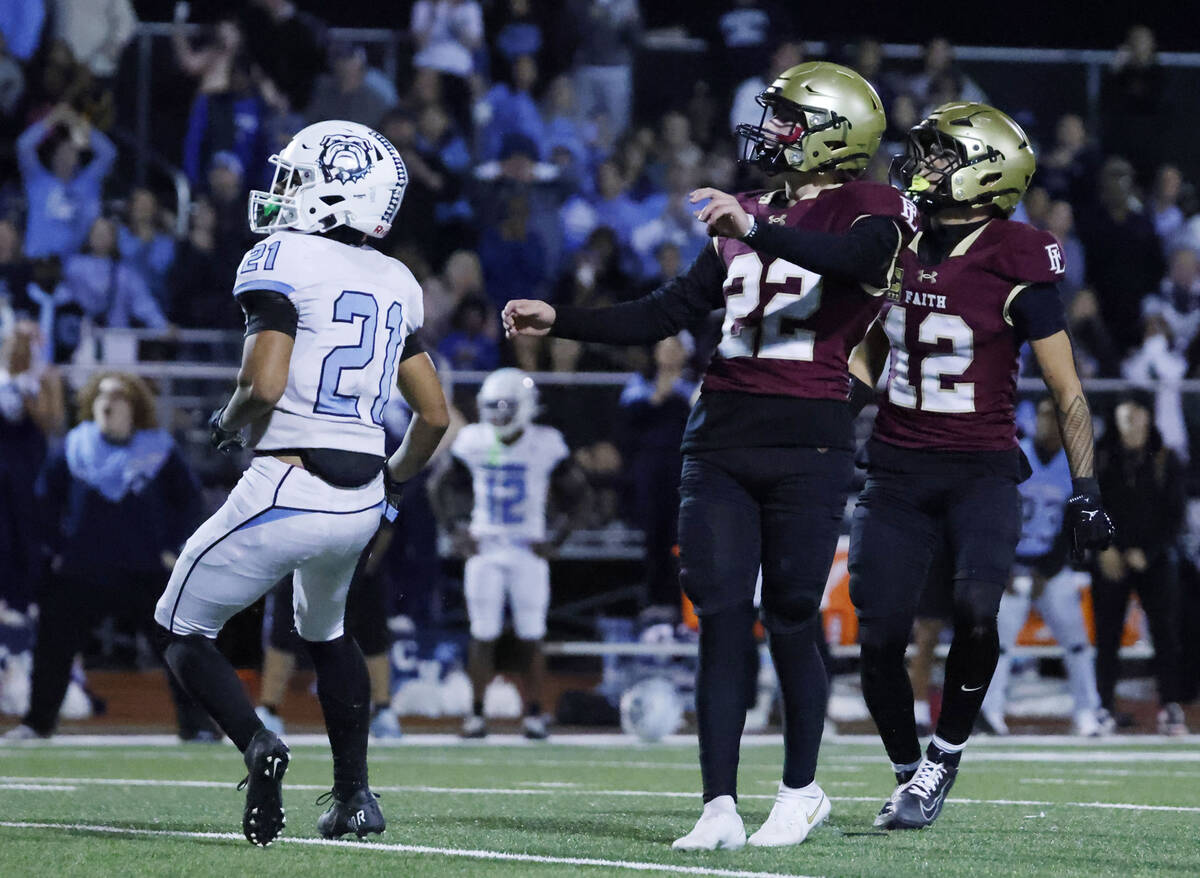 Faith Lutheran kicker Liam Radke, 22, wide receiver Aipa Kuloloia (12) and Centennial cornerba ...