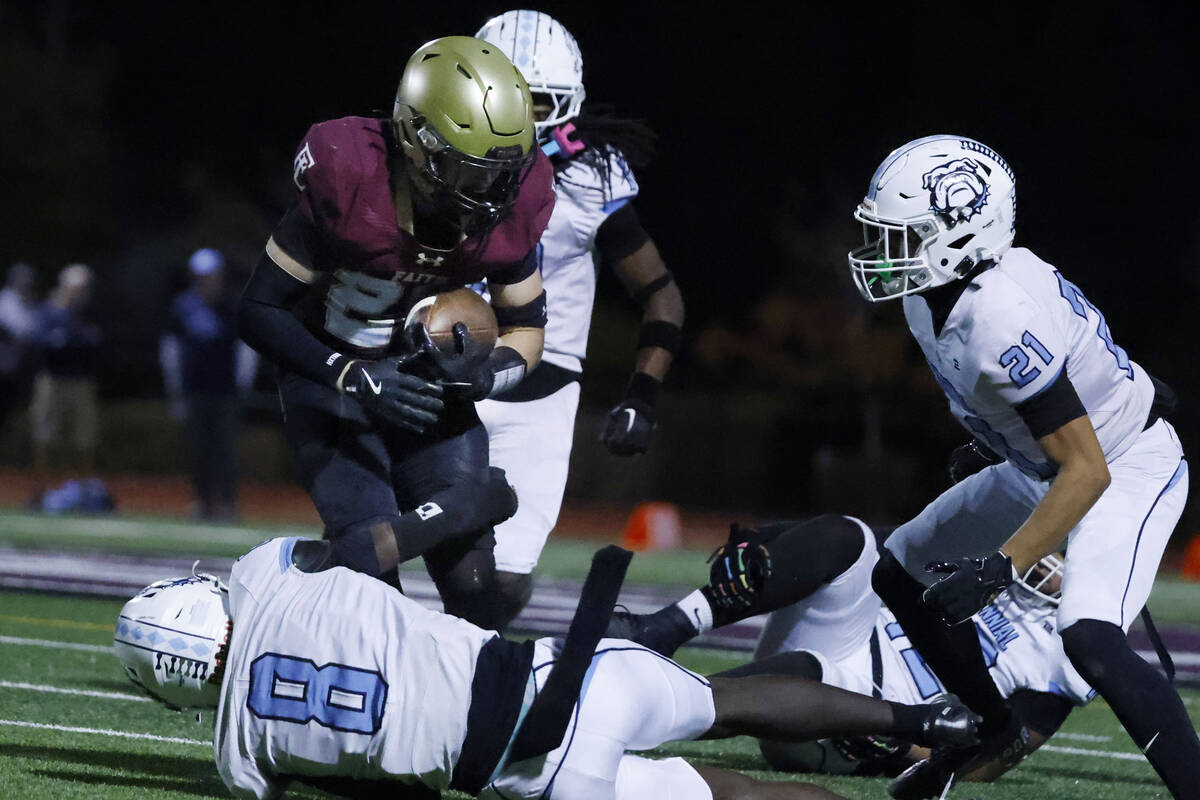 Faith Lutheran linebacker Weston Schultz (26) breaks the tackle from Centennial safety Maxwell ...