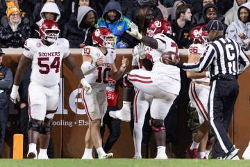 Oklahoma quarterback John Mateer (10) celebrates a touchdown with offensive lineman Logan Howla ...