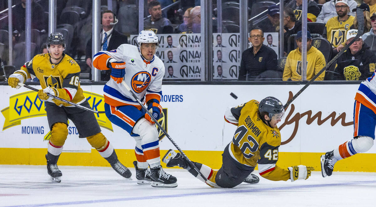 Golden Knights right wing Braeden Bowman (42) is taken down as he drives with the puck against ...