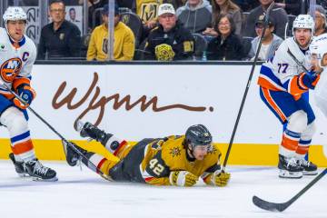 Golden Knights right wing Braeden Bowman (42) is taken down as he drives with the puck against ...