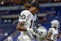 Raiders wide receiver Dont'E Thornton Jr. (10) prepares to put his helmet on before an NFL ...