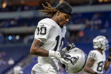 Raiders wide receiver Dont'E Thornton Jr. (10) prepares to put his helmet on before an NFL ...
