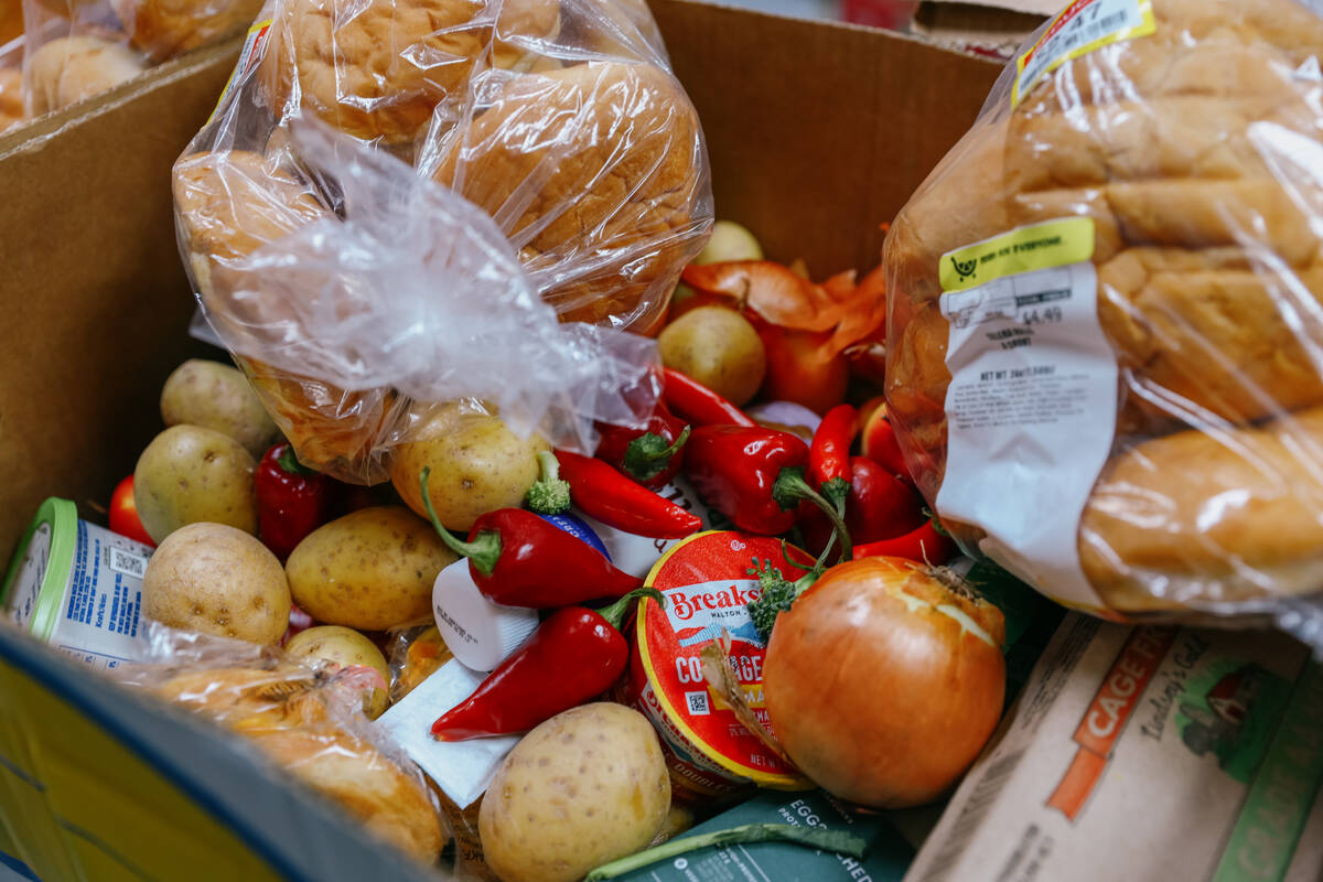 A box of food, enough to feed a family of four for a week, sits ready for pickup at City Impact ...