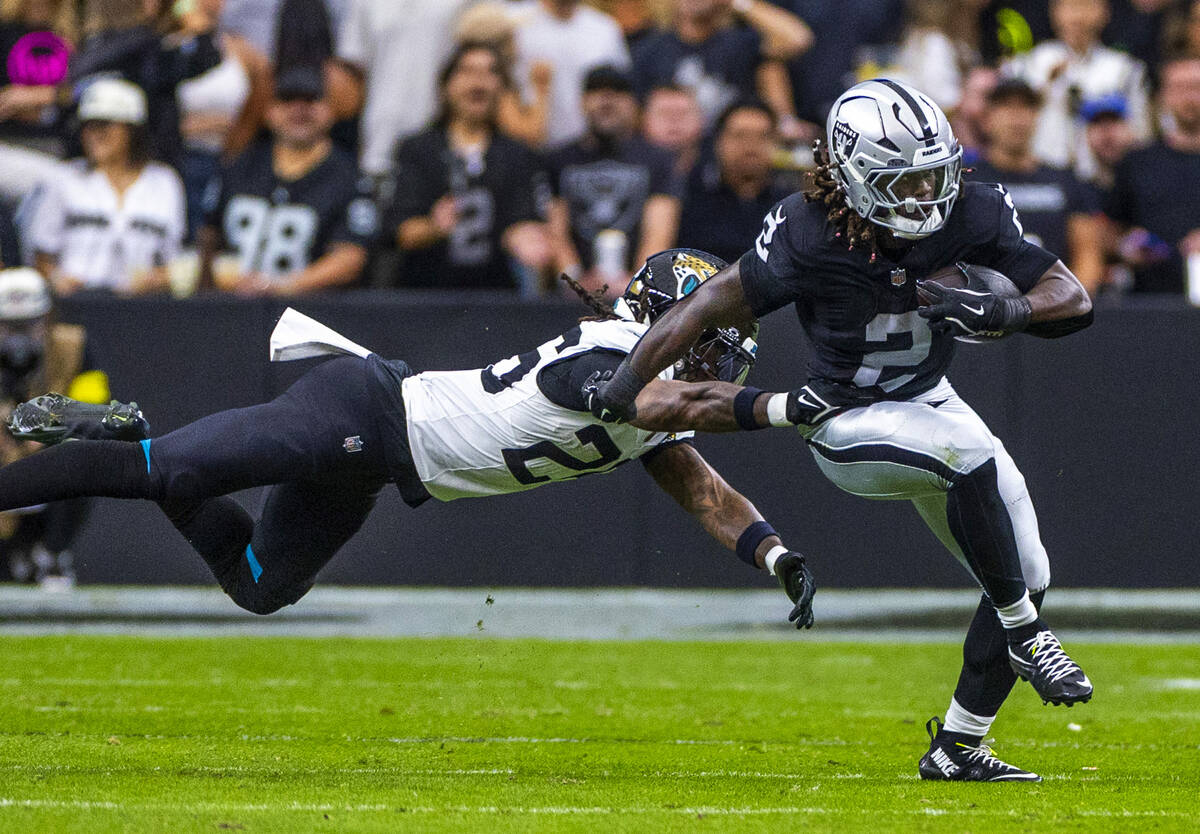 Raiders running back Ashton Jeanty (2) breaks away from Jacksonville Jaguars safety Antonio Joh ...
