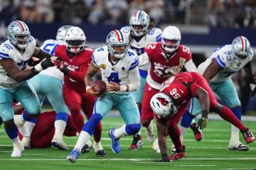 Dallas Cowboys quarterback Dak Prescott (4) is pressured out of the pocket by Arizona Cardinals ...