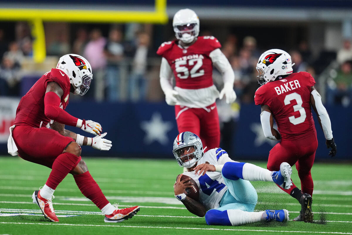 Dallas Cowboys quarterback Dak Prescott (4) slides to a stop after gaining yards on a run as Ar ...
