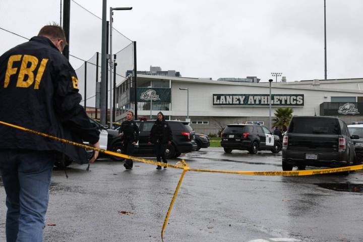 Law enforcement work the scene after a shooting at Laney College in Oakland, Calif., on Thursda ...