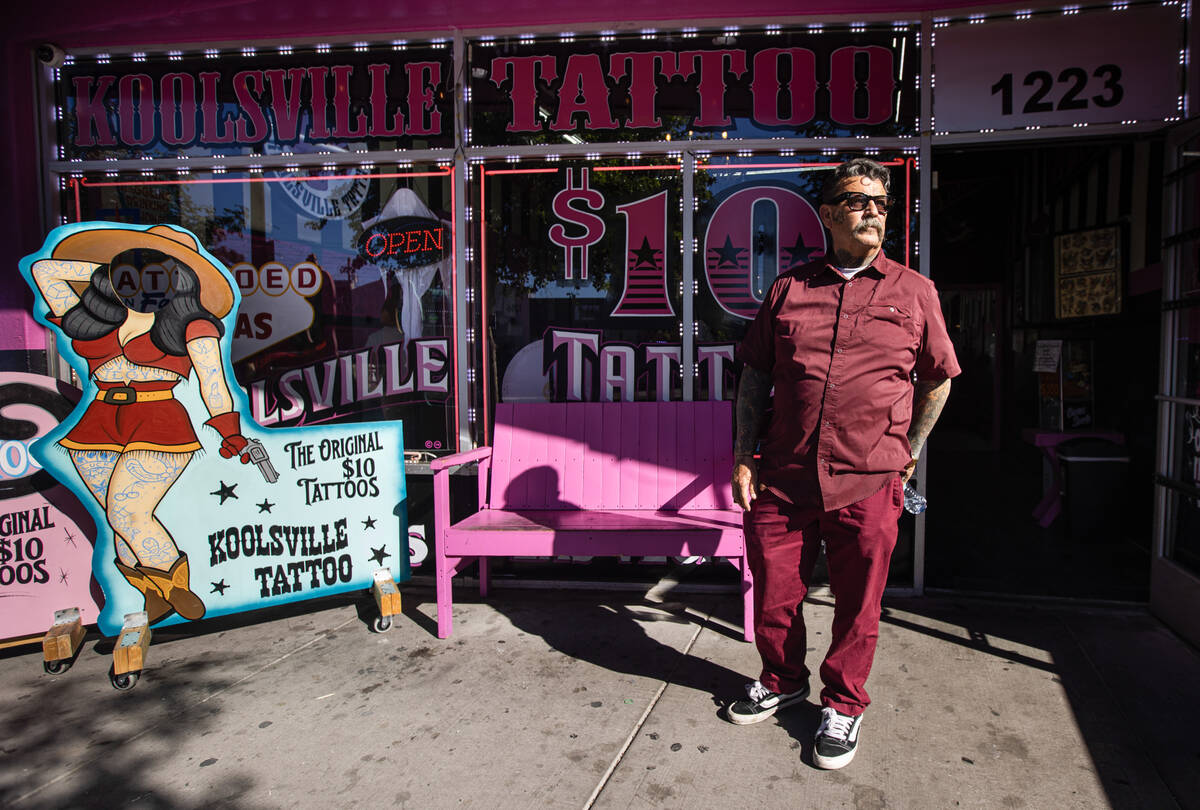 Robert Gonzalez, who owns Koolsville Tattoos with wife Mari Gonzalez, poses for a portrait outs ...