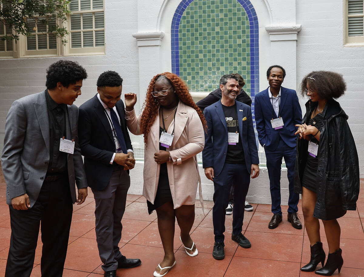 Arash Ghafoori, third from right, CEO of Nevada Partnership for Homeless Youth, interacts with ...