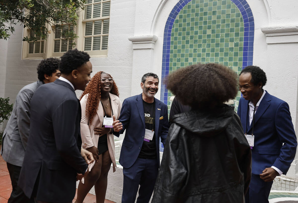 Arash Ghafoori, middle, CEO of Nevada Partnership for Homeless Youth, speaks with members of NP ...