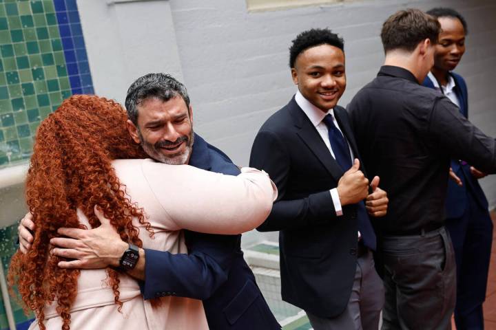 Arash Ghafoori, facing/left, CEO of Nevada Partnership for Homeless Youth, interacts with membe ...
