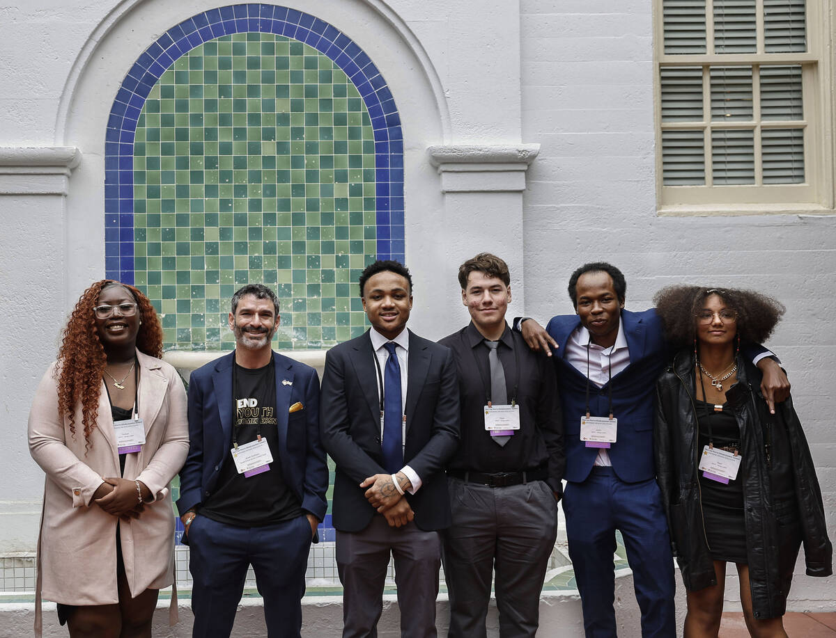 Arash Ghafoori, second from left, CEO of Nevada Partnership for Homeless Youth, poses for a pho ...