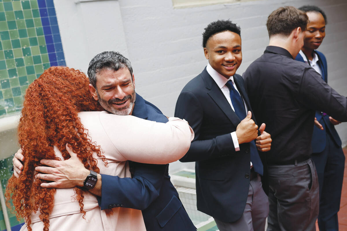 Arash Ghafoori, facing/left, CEO of Nevada Partnership for Homeless Youth, interacts with membe ...