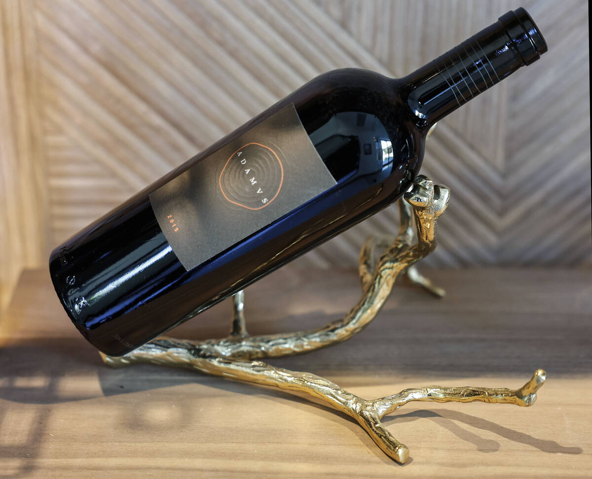 A wine bottle featured in a refrigerated wine room with metal and acrylic wince racks by Las Ve ...