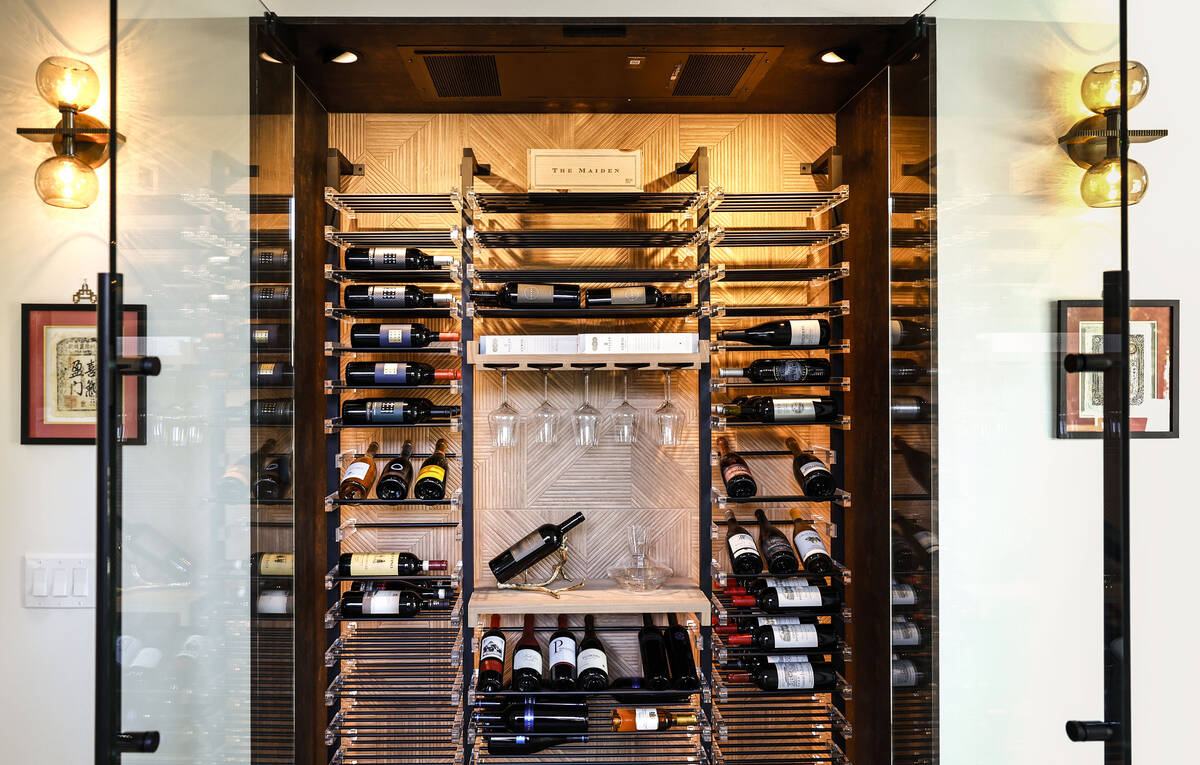 A refrigerated wine room with metal and acrylic wince racks by Las Vegas Wine Cellars is photog ...