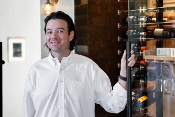 Eric Murphy, owner of Las Vegas Wine Cellars, poses for a portrait in front of a refrigerated w ...