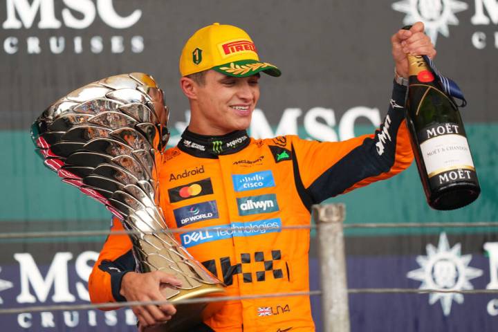 McLaren driver Lando Norris of Britain celebrates on the podium his first place in the Brazilia ...