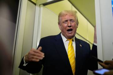 President Donald Trump speaks to reporters on Air Force One on his way to his Mar-a-Lago estate ...