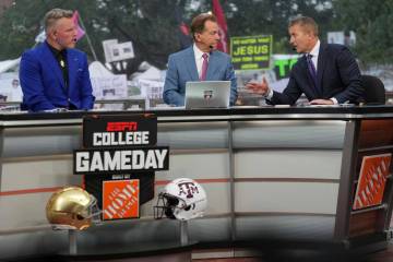 FILE - From left, Pat Mcafee, Nick Saban and Kirk Herbstreit talk on the set of ESPN College Ga ...