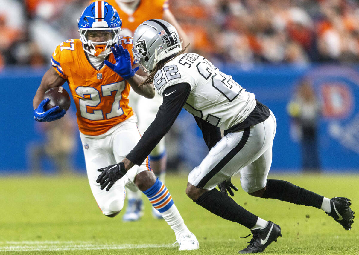 Raiders cornerback Eric Stokes (22) pursues Denver Broncos running back J.K. Dobbins (27) durin ...