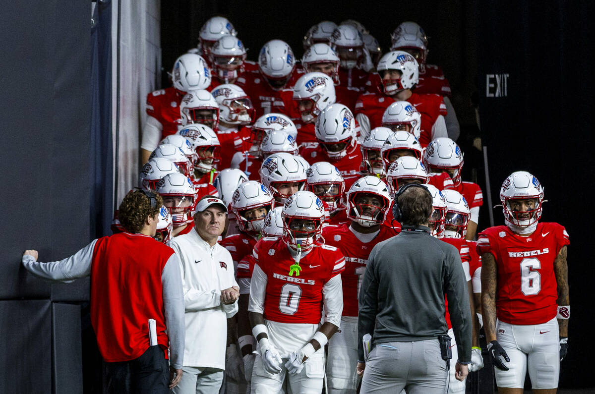 UNLV head coach Dan Mullen and his players wait to leave the tunnel to face Utah State during t ...