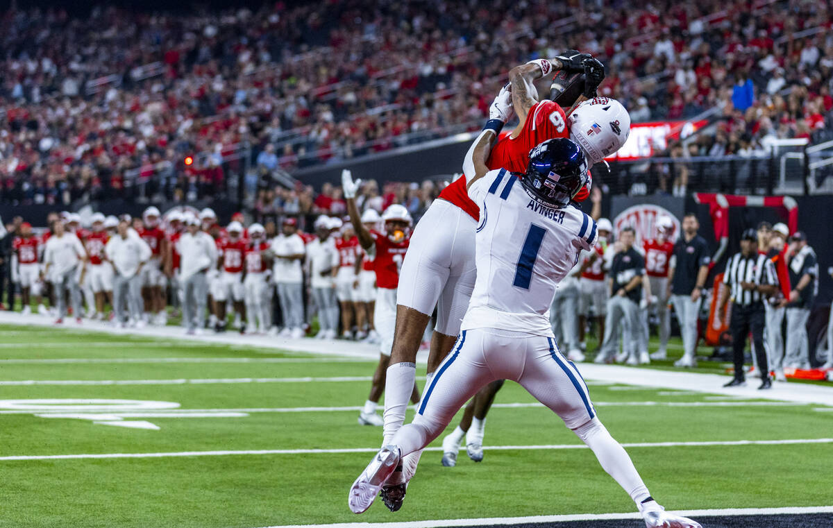 UNLV wide receiver Jaden Bradley (6) attempts a touchdown reception defended by Utah State Aggi ...