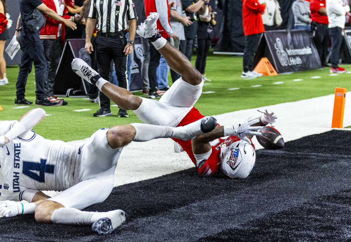 UNLV tight end Var'Keyes Gumms (30) loses a pass in the end zone as Utah State Aggies safe ...