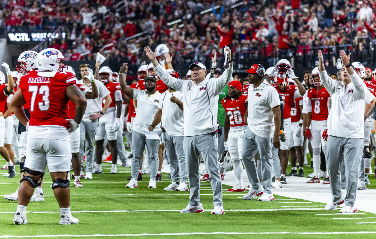 UNLV head coach Dan Mullen and his team await the scoring decision by the referees on their way ...