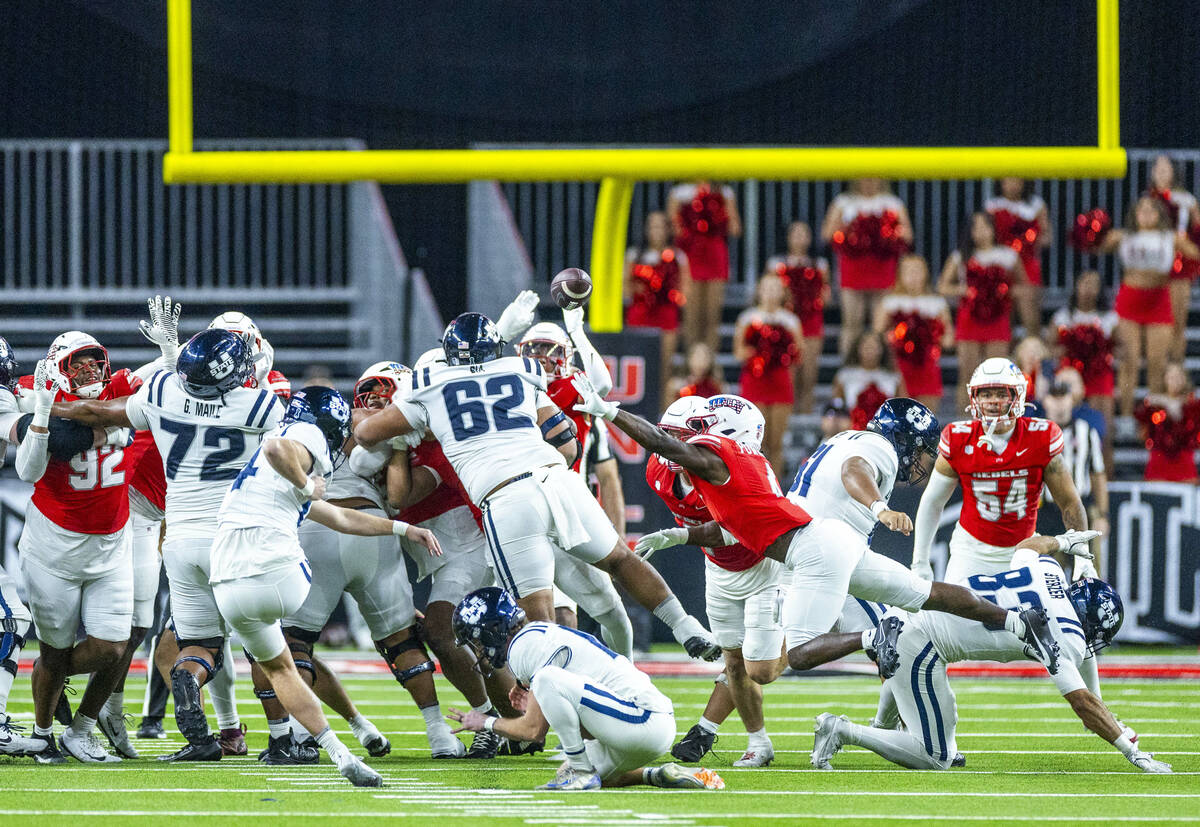 UNLV defensive back Andrew Powdrell (4) leaps in to disrupt the timing of Utah State Aggies kic ...