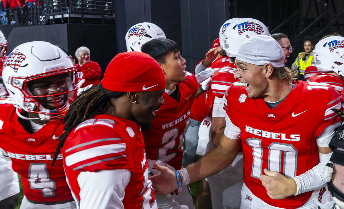 UNLV quarterback Anthony Colandrea (10) celebrates their overtime win with teammates against Ut ...