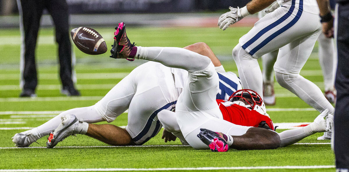 UNLV linebacker Chief Borders (1) sacks Utah State Aggies quarterback Bryson Barnes (16) causin ...