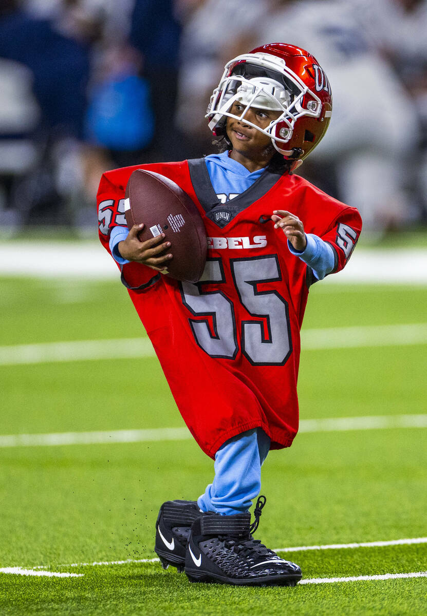 A young fan smiles as she wins the uniform dressing race in a timeout with UNLV and Utah State ...