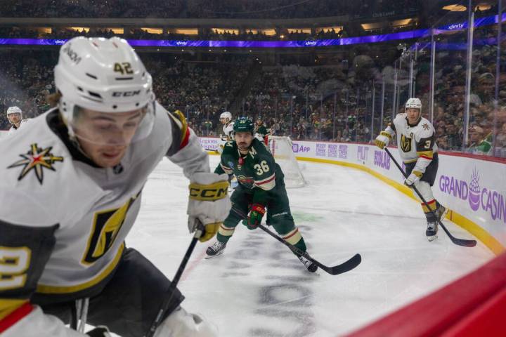 Minnesota Wild player Mats Zuccarello, center, and Vegas Golden Knights players Braeden Bowman, ...