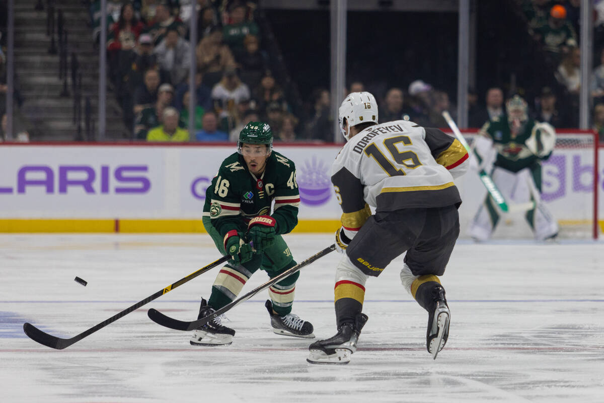 Minnesota Wild player Jared Spurgeon, left, and Vegas Golden Knights player Pavel Dorofeyev go ...