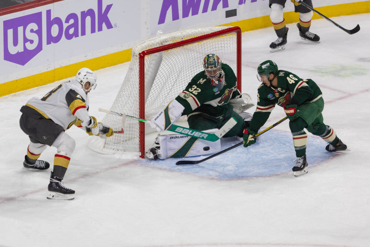 Minnesota Wild goaltender Filip Gustavsson, center, and teammate Jared Spurgeon, right, block a ...