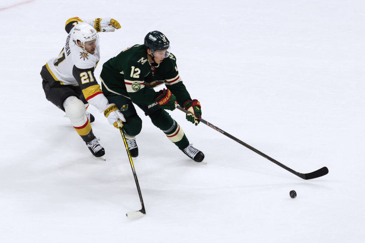 Vegas Golden Knights player Brett Howden, left, and Minnesota Wild player Matt Boldy, right, co ...