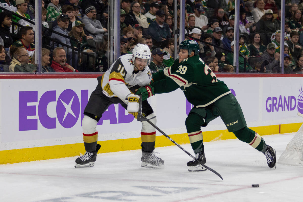 Minnesota Wild player Ben Jones, right, pushes Vegas Golden Knights player Colton Sissons durin ...