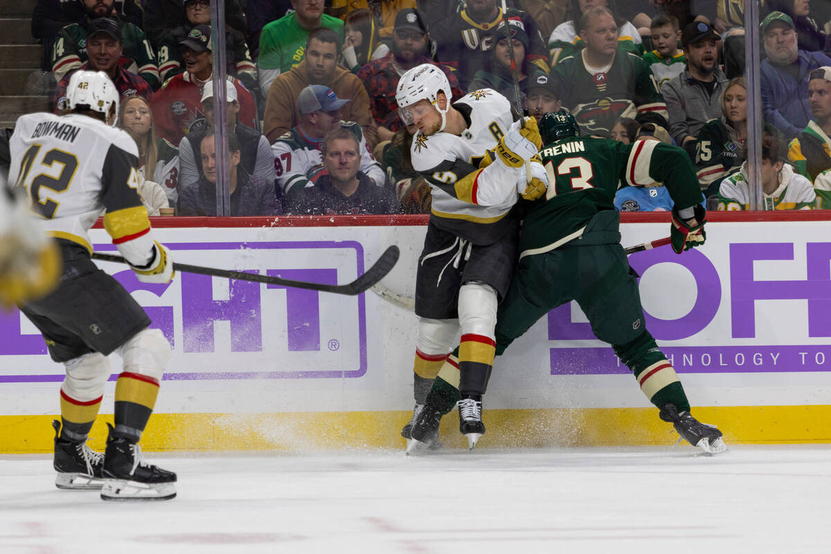 Vegas Golden Knights player Jack Eichel and Minnesota Wild player Yakov Trenin compete for the ...