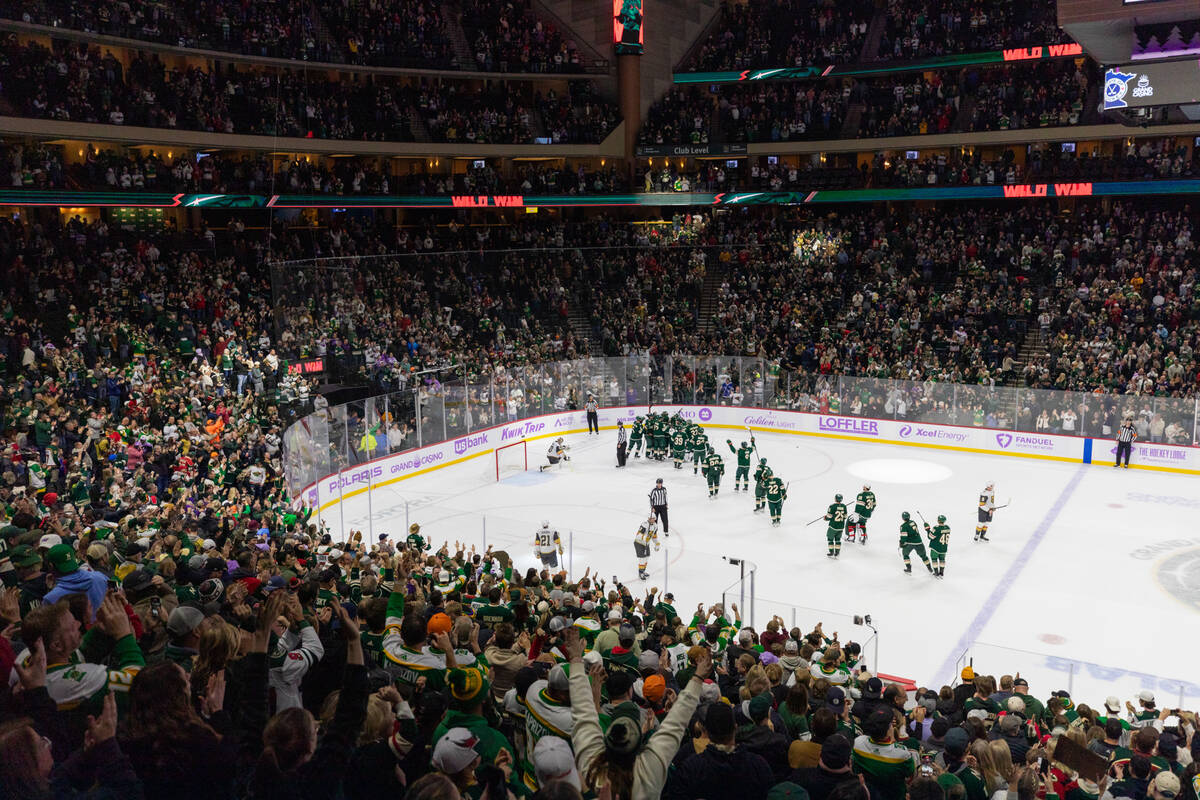 Minnesota Wild fans cheer while players celebrate on the ice after they defeated the Vegas Gold ...