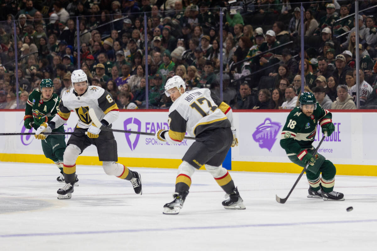 Minnesota Wild player Vinnie Hinostroza, right, controls the puck against the Vegas Golden Knig ...