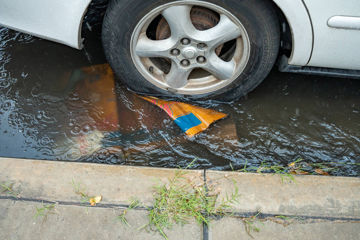 Water levels rise at the intersection of N. Jones Blvd and W. Washington Ave Tuesday afternoon ...