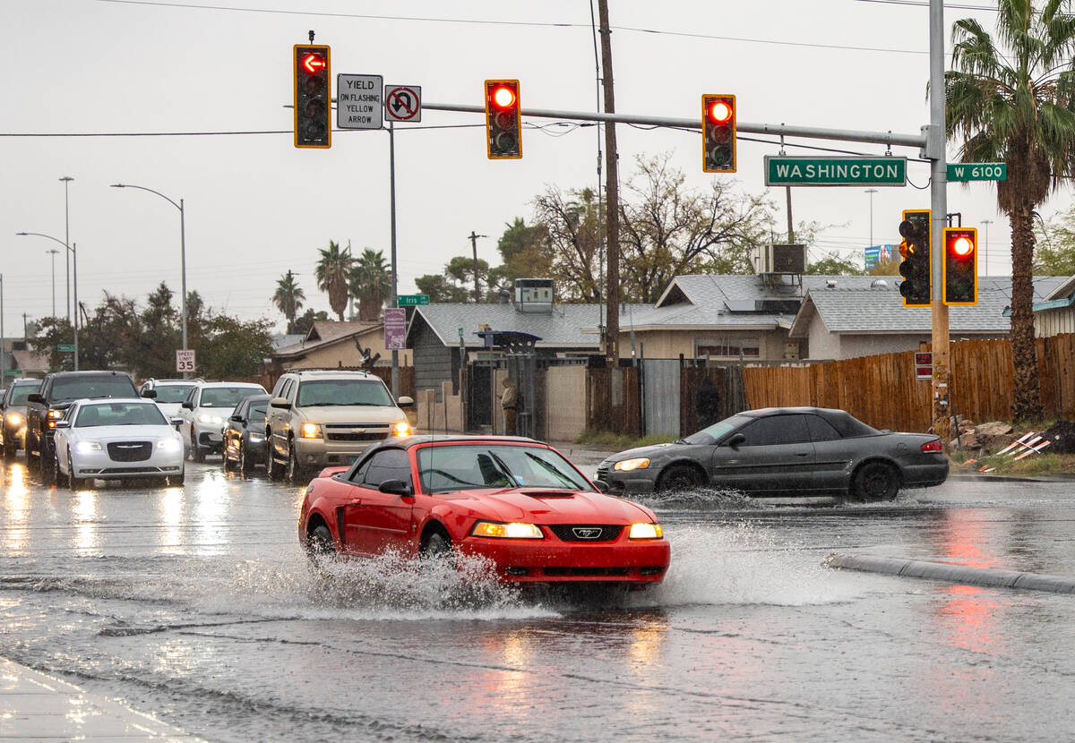 Water levels rise at the intersection of N. Jones Blvd and W. Washington Ave Tuesday afternoon ...