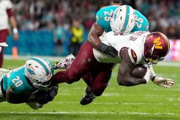 Washington Commanders wide receiver Deebo Samuel (1) is tackled by Miami Dolphins linebacker Jo ...