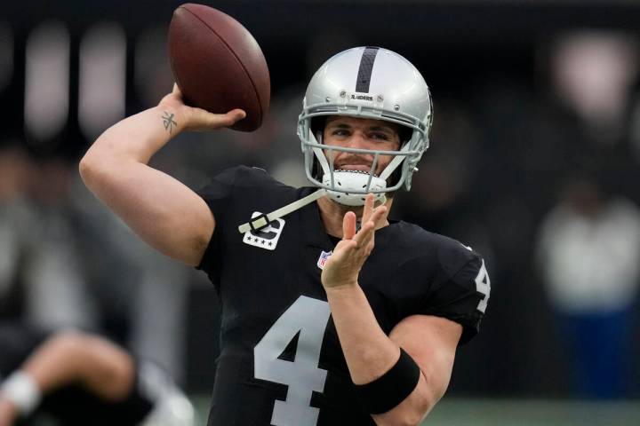 Las Vegas Raiders quarterback Derek Carr (4) warms up before an NFL football game against the N ...