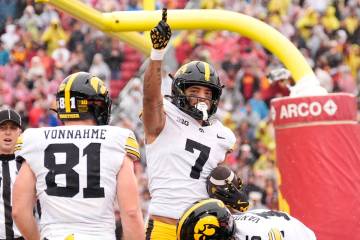 Iowa wide receiver Dayton Howard, center, celebrates his touchdown as tight end DJ Vonnahme wat ...