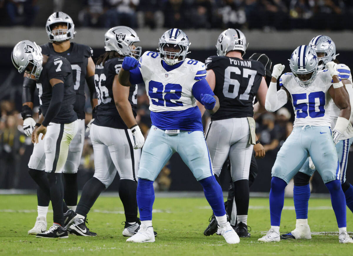 Raiders quarterback Geno Smith (7) walks off the field as Dallas Cowboys defensive tackle Quinn ...