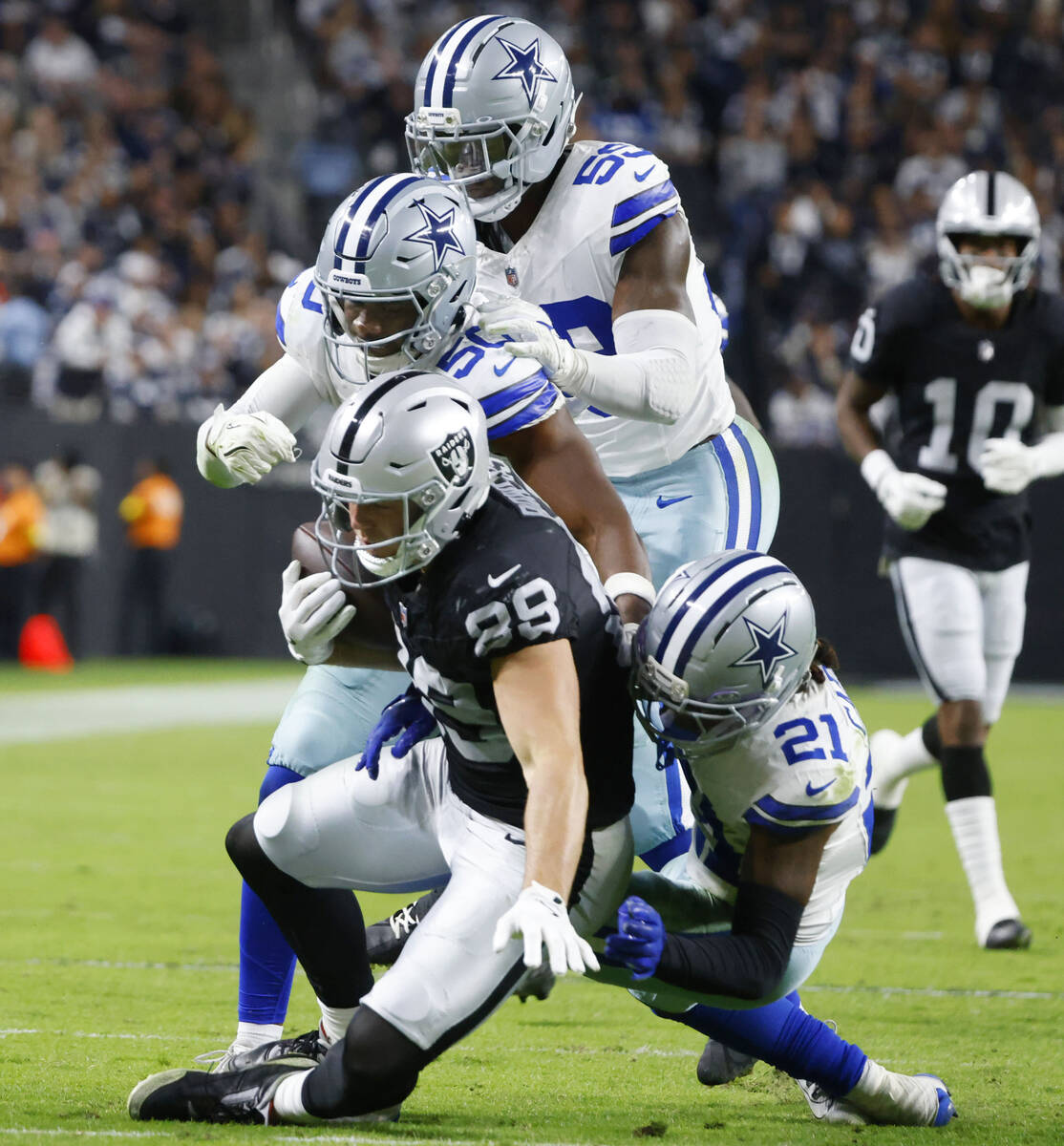 Raiders safety Chris Smith II (29) is taken down by Dallas Cowboys defense during the second ha ...