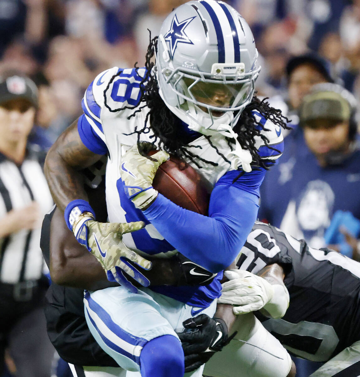 Dallas Cowboys wide receiver CeeDee Lamb (88) breaks a tackle during the second half of an NFL ...