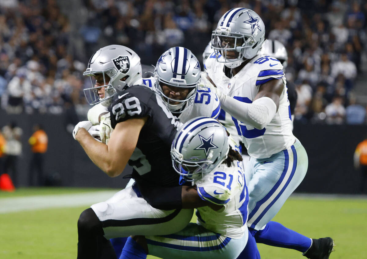 Raiders safety Chris Smith II (29) is taken down by Dallas Cowboys defense during the second ha ...